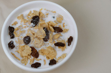 Cereal and Raisin with Milk for Breakfast Meal.