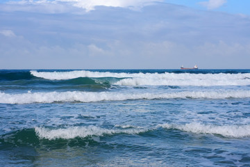 Fototapeta premium A ship in the sea is a view from the shore.