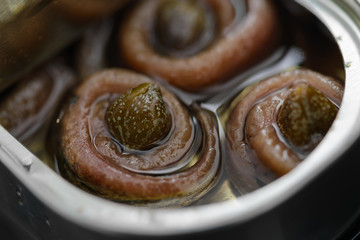 Fototapeta Anchovy rolls with capers in olive oil in tin. Close up obraz