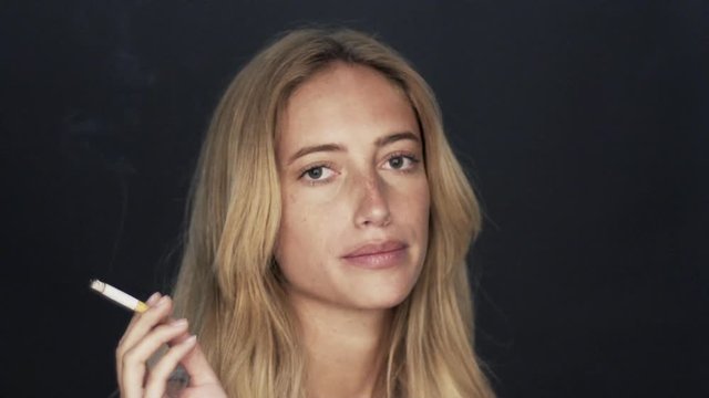 Young woman smoking cigarette