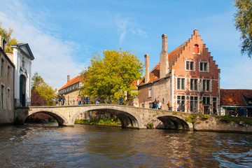 Fototapeta na wymiar Water canal with old bridge and medieval houses at Begijnhof, Bruges, Belgium.