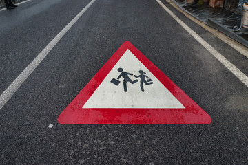 School Sign, children student crossing sign on the street after raining