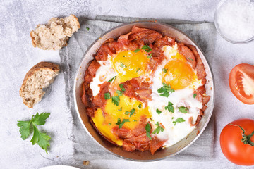 Fried eggs with bacon in frying pan