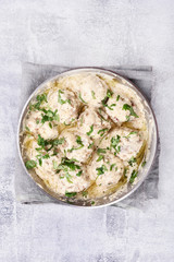 Meatballs with white sauce and green herbs