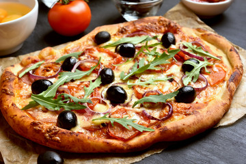 Pizza with tomato, salami and olives