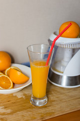 Orange juice. fruits and Electric Juice Machine on wooden desk