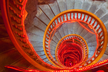 Spiral stone stairs with red painted balustrade
