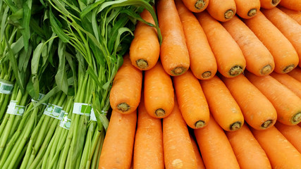 Heap of farm grown fresh carrot and vegetable Ready for sell of Chinese morning glory in the market
