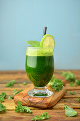 Green smoothies on wooden table