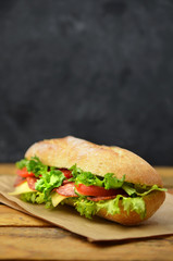 Sandwich on wooden table.