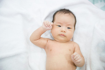 A little girl sleep on white towel