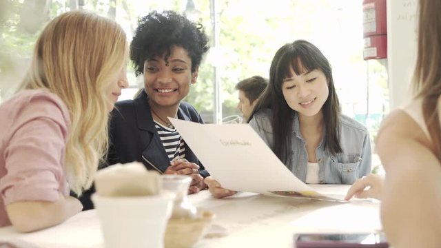 Women reading menu in restaurant