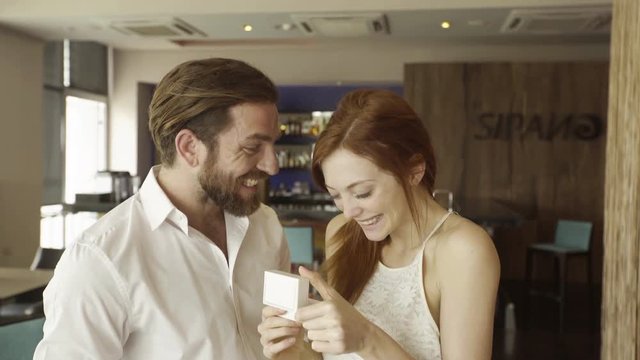 Man giving girlfriend engagement ring