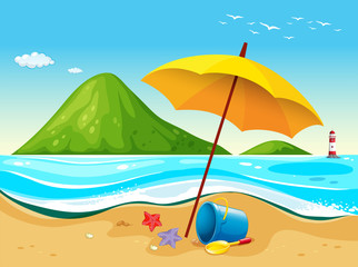 Fototapeta na wymiar Beach scene with umbrella and toys