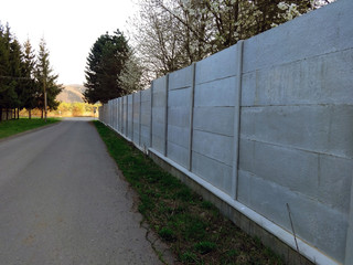 The road next to the concrete fence