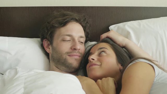 Coupld embracing in bed