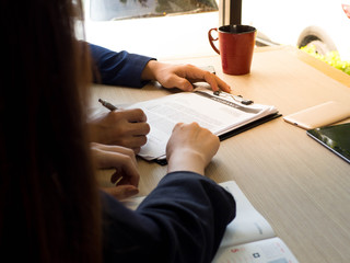 Hands of two business signed the document