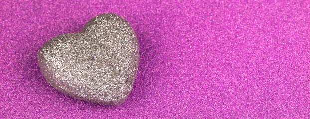 Shiny purple glitter paper and heart shape texture background.