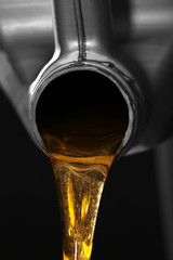 Engine oil pouring from canister, closeup