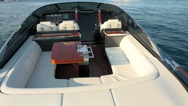 Sofas and table in the cockpit of a luxury vintage wooden boat.