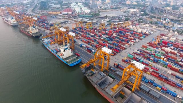 Aerial view of container ships and lifting cranes in the Port of Bangkok. Aerial view by drone; container ships at Bangkok. Aerial shot of the containers on sunset.