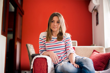 Obraz premium Girl on sofa in living room