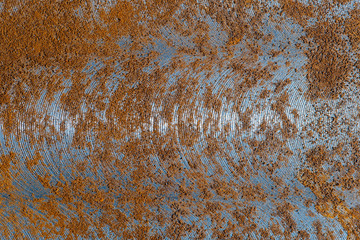 An abstract metal background with signs of wear and rust. Macro shot of metal surface.