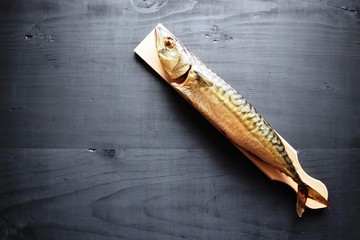 Smoked fish with lemon, on wooden board, Mackerel