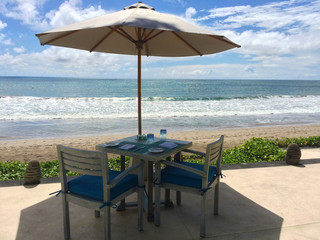Table with two chairs near sea