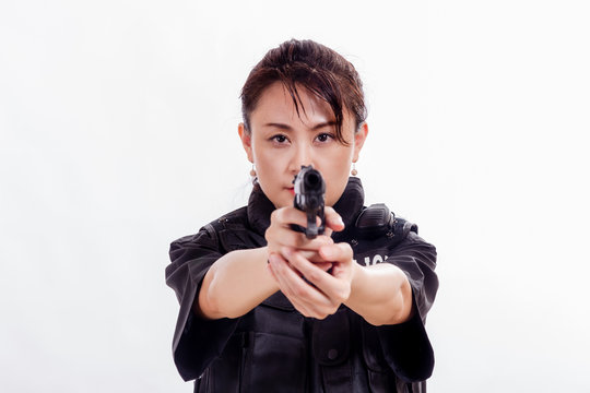 Chinese woman police officer pointing pistol