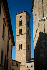 VOLTERRA, TUSCANY - MAY 21, 2017 - Baptistery of San Giovanni Battista and tower of Cathedral