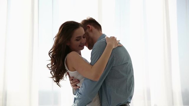 Beautiful couple in love having fun at home