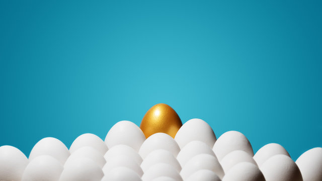 Concept Of Individuality, Exclusivity, Better Choice. One Golden Egg Among White Eggs On Blue Background.