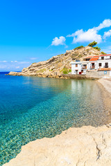Beautiful pebble stone beach with typical Greek houses of Kokkari village on sunny summer day, Samos island, Greece