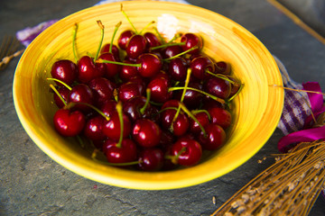Sweet cherries on rustic wooden background