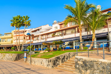 Fototapeta na wymiar Restaurants on coastal promenade in La Caleta town on southern Tenerife, Canary Islands, Spain