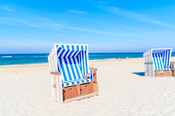 Wicker chairs on white sand Kampen beach, Sylt island, North Sea, Germany