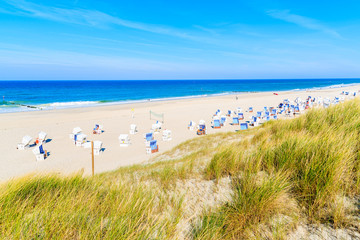 Wicker chairs on white sand Kampen beach, Sylt island, North Sea, Germany