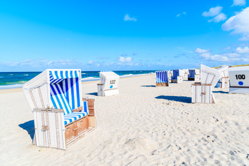 Wicker chairs on sandy beach in Kampen village on Sylt island, North Sea, Germany