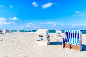 Wicker chairs on sandy beach in Kampen village on Sylt island, North Sea, Germany