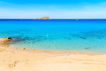 Fototapeta na wymiar View of beautiful Cala Comte beach famous for its azure crystal clear shallow sea water, Ibiza island, Spain