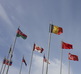 Flags of different countries on a background of blue sky