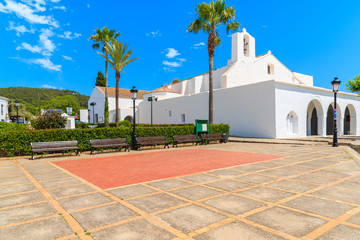 Square with white church and palm trees in Sant Carles de Peralta village, Ibiza island, Spain © pkazmierczak