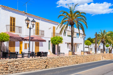 Typical Spanish style houses and palm tree on street of Sant Josep de sa Talaia town, Ibiza island, Spain