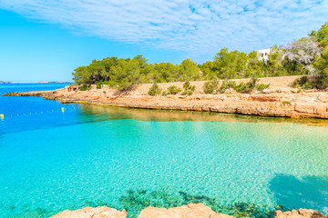 View of beautiful Cala Gracioneta bay with crystal clear sea water at early morning, Ibiza island, Spain