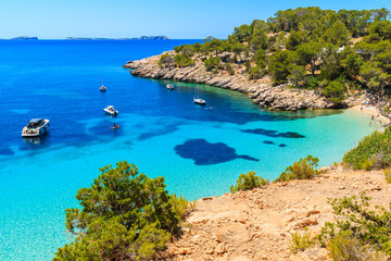 View of beautiful beach in Cala Salada bay famous for its azure crystal clear sea water, Ibiza...