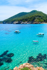 Plakat Fishing boats on turquoise sea water in Cala San Vicente bay, Ibiza island, Spain