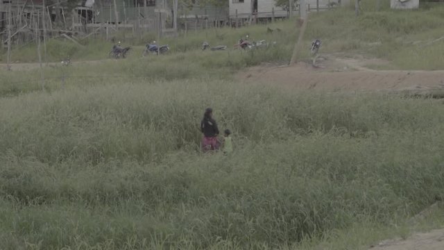 woman and son walking on path 