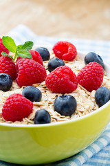 Oatmeal porridge with berries. Raspberries and blueberries.