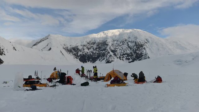 Time lapse view of climbers preparing to leave campsite, Denali National Park, Alaska, USA